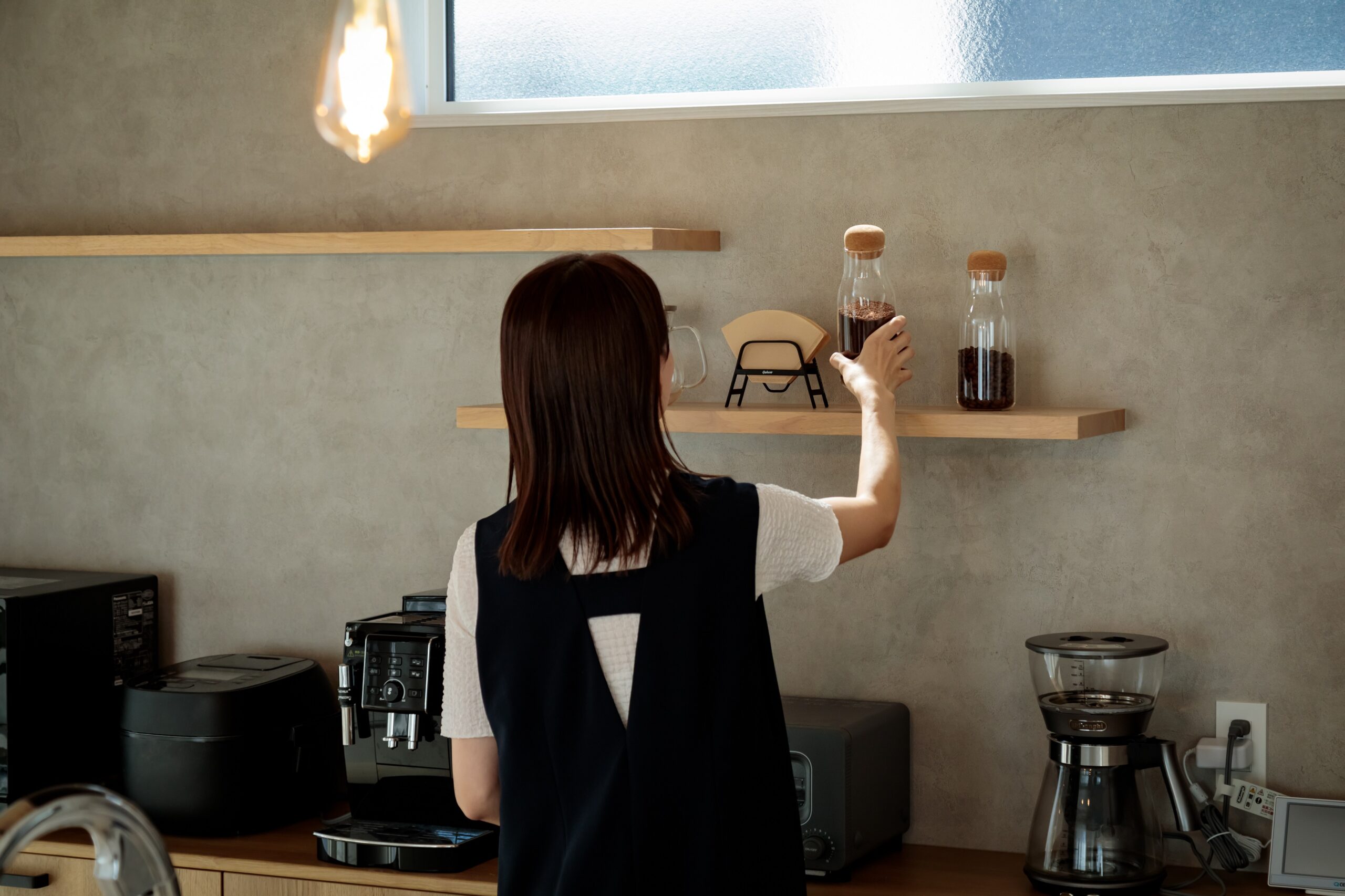 高さを変えて取り付けた2段の飾り棚にお気に入りのアイテムをディスプレイし、カフェ風のコーディネートを楽しんでいる奥様。お洒落なキッチン空間が料理へのモチベーションを高めてくれます。